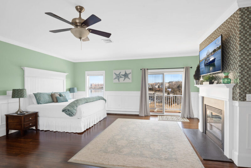 beacon waterfront inn guestroom with bed, fireplace, television